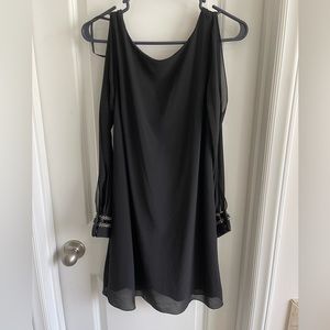 Black cocktail dress with embellished cuffs and cutout sleeves